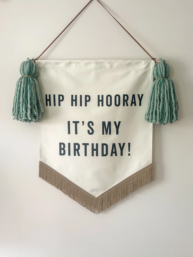 Large handmade fabric birthday banner with green tassels and gold bullion trim