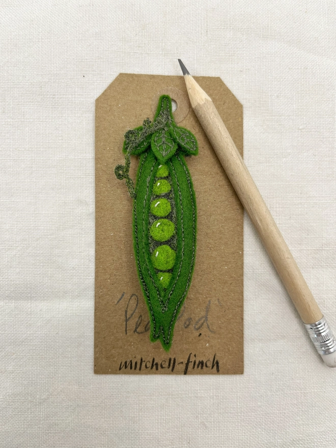 Pea Pod brooch on label