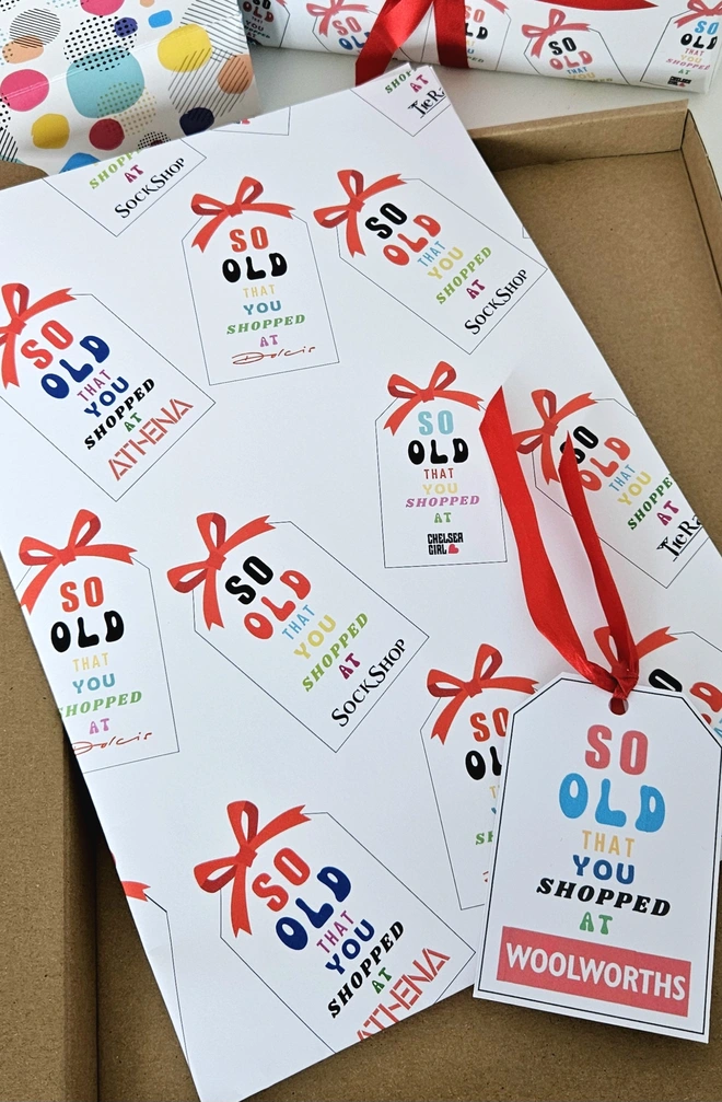 A photograph of wrapping paper and a present the design says so old that you shopped at Woolworths and other shops popular in the 1970's and 1980's