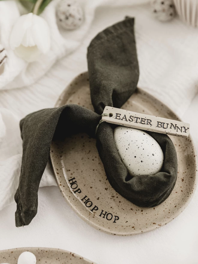 ceramic egg shaped plate with the words 'hop hop hop' around the edge