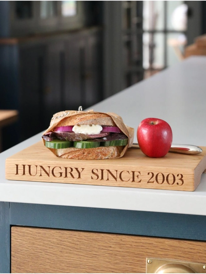 Hungry since engraved oak chopping board