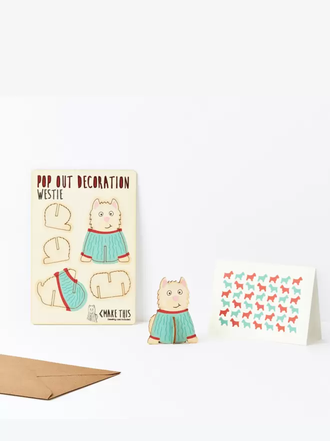 Westie dog decoration and West Highland Terrier pattern greeting card and brown kraft envelope on a white background