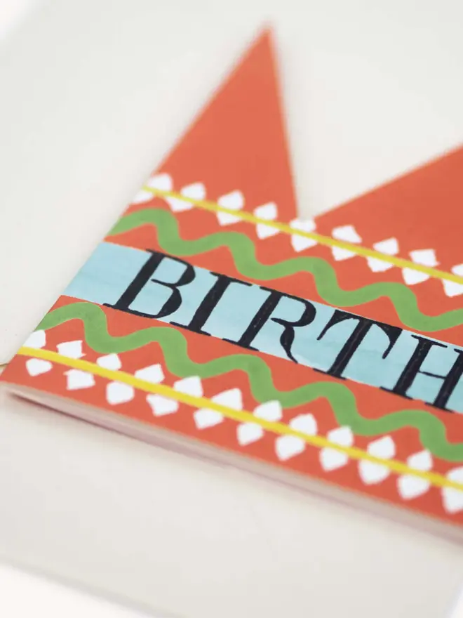 red paper crown card with birthday king text