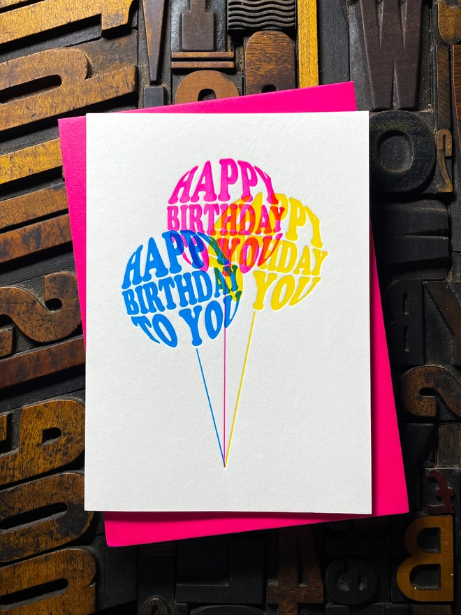 Birthday card with typographic design on three colourful balloons letterpress card. Deep impression print. Unique with no print being the same. They show slight colour variations adding to the style comes with premium quality colourful envelopes.