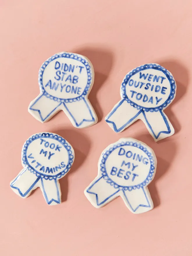  Blue Handmade Ceramic Award, a group of blue and white ceramic award badges sitting on a ink surface. 