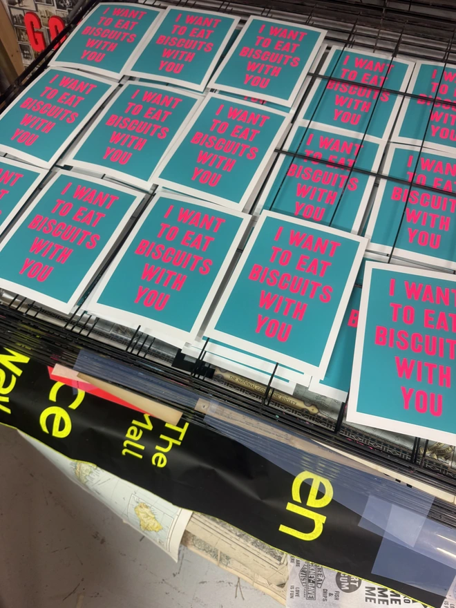 Group shot of 'I Want to Eat Biscuits with You' bright blue screen prints in progress