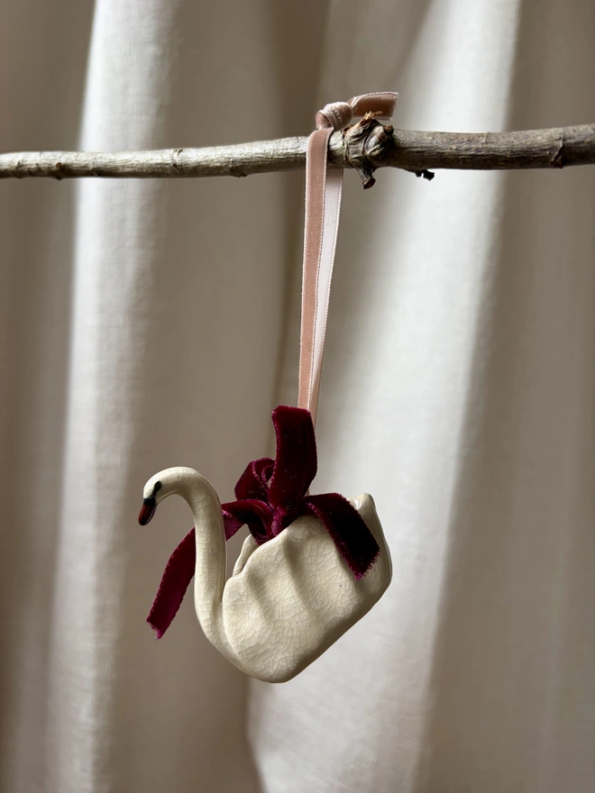 Ceramic swan Christmas tree decoration in white crackle glaze with velvet ribbon and bow
