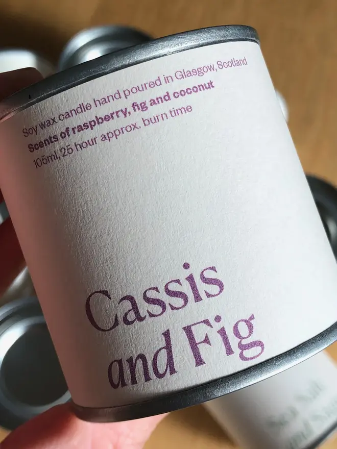 Cassis & Fig Candle, displayed against a wooden background. 