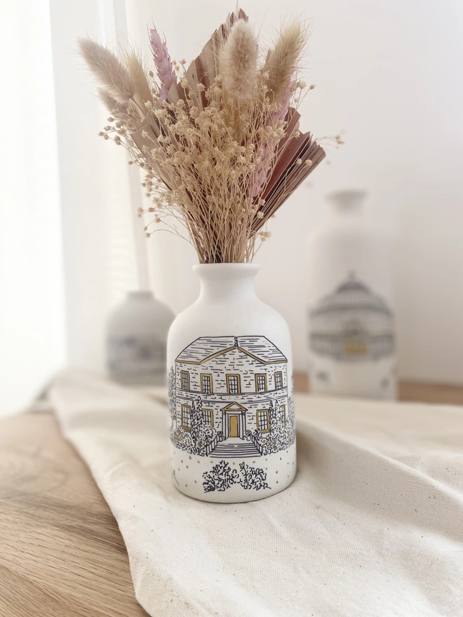 The back of a ceramic vase with black hand written personalisation  