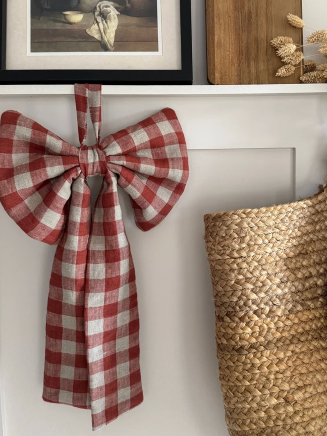 Rusty Gingham Bow. A bow hanging in a home.