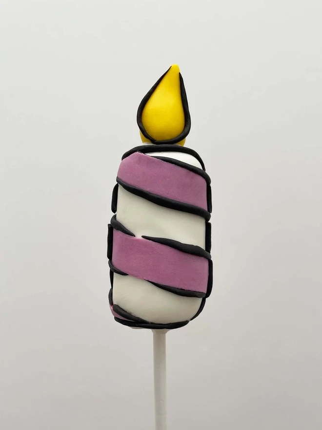 Cartoon Birthday Candle Cake Pops (Pack Of 6, 12, 18, 24), Birthday candle cake pop decorated in purple swirl placed in front of a white background.