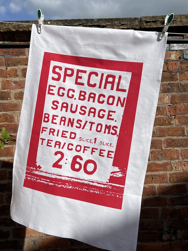 Mr.PS Big Breakfast tea towel hanging in the sunshine