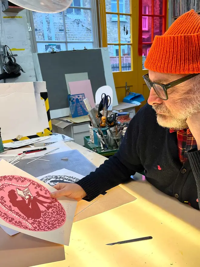 Image of Rob looking at the artwork in his studio