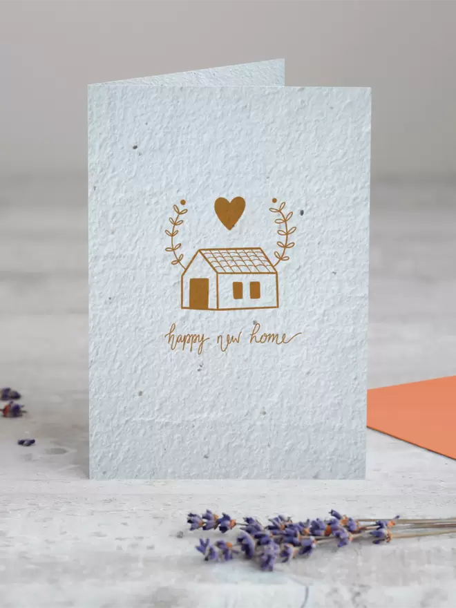 Seed Card with an illustration of a house with a heart and leaves above it with ‘Happy New home’ written beneath with a sprig of Lavender placed in the foreground