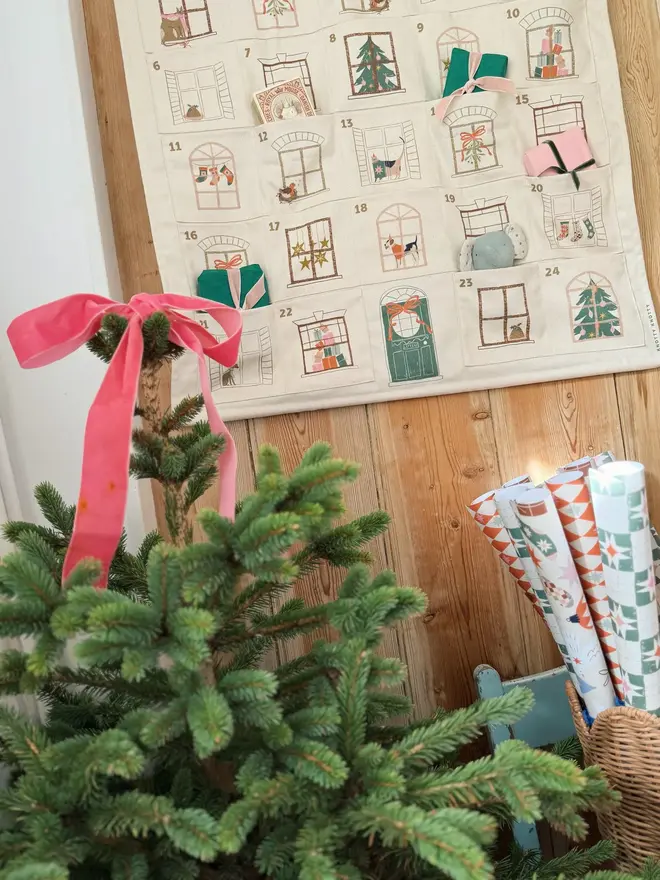 Fabric Christmas House Advent Calendar, hanging on a door. 