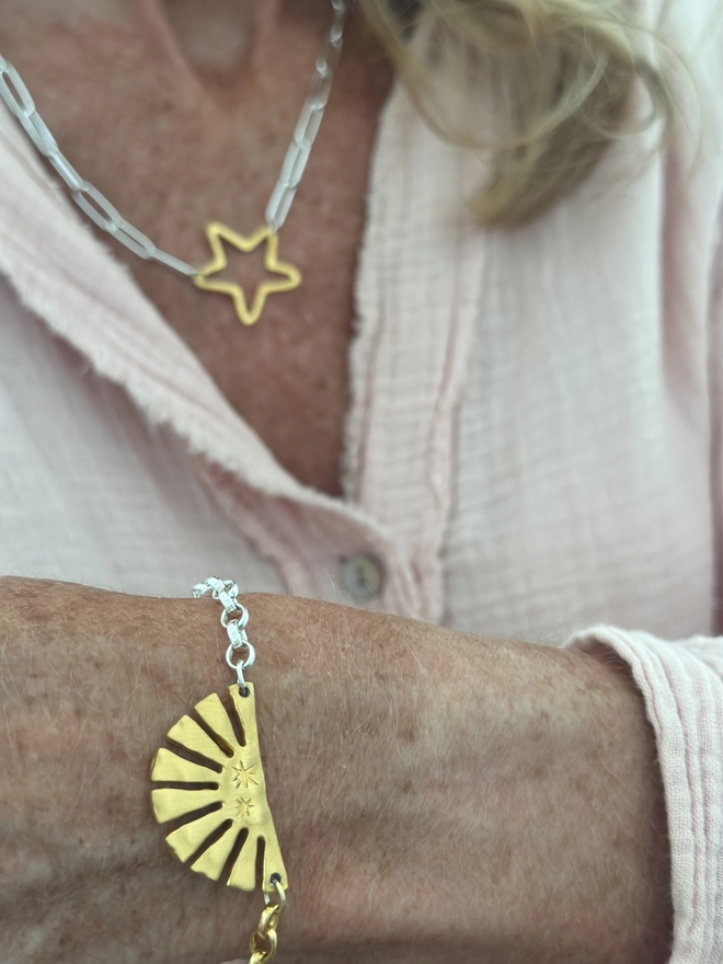 Model wears a gold plate sun charm on a mixed metal belcher chain