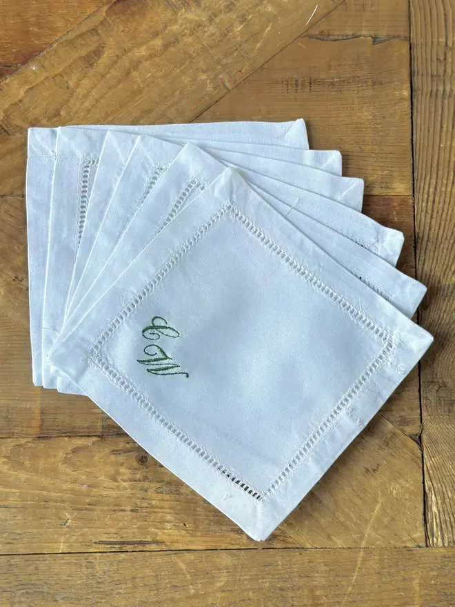 white cocktail napkin with embroidered initials CW