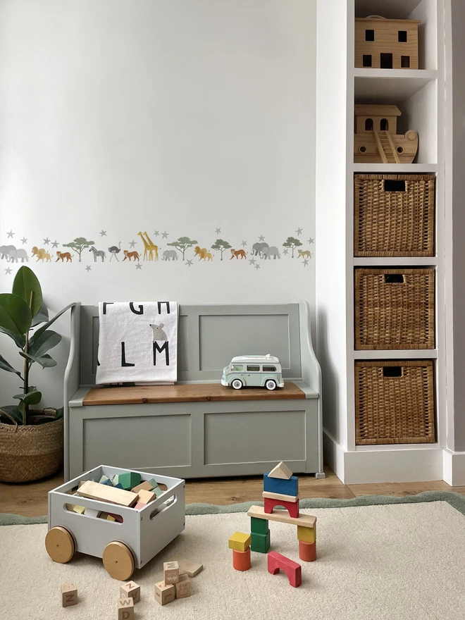 Ducks In A Row Safari Fabric Wall Stickers in Kids Playroom with Toy Bench, building blocks and built in storage unit