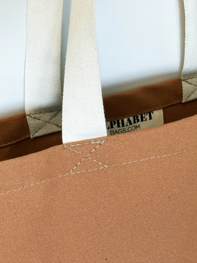 Close up of the tan canvas of the Everything oversized tote bag