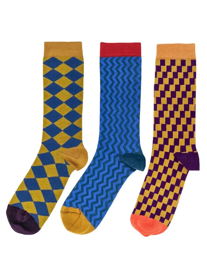 Men's Organic Cotton Ankle Socks Packs (Sets Of 3), a set of colourful patterned socks sitting on a plain white surface. 