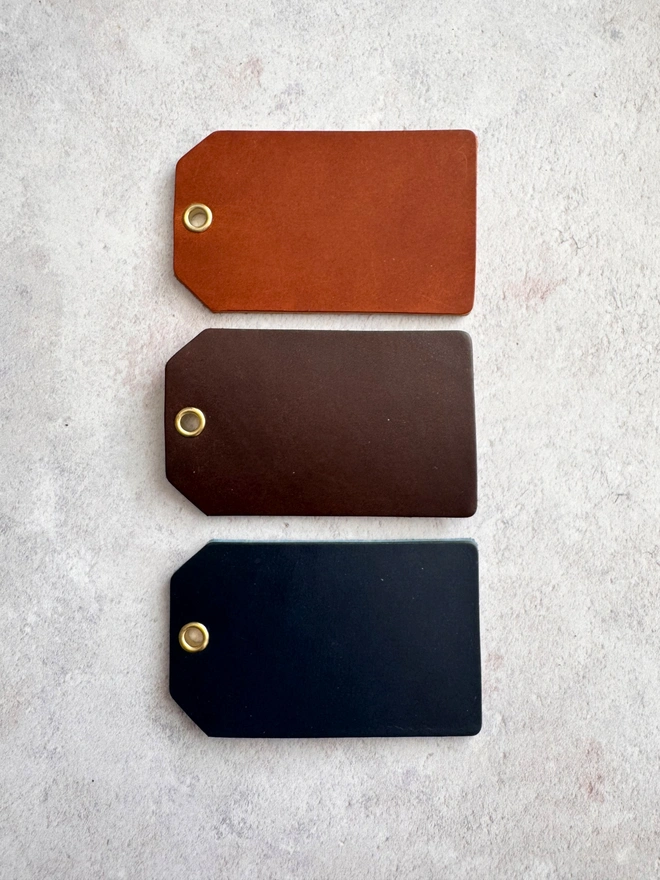 tan, brown and navy leather luggage tags