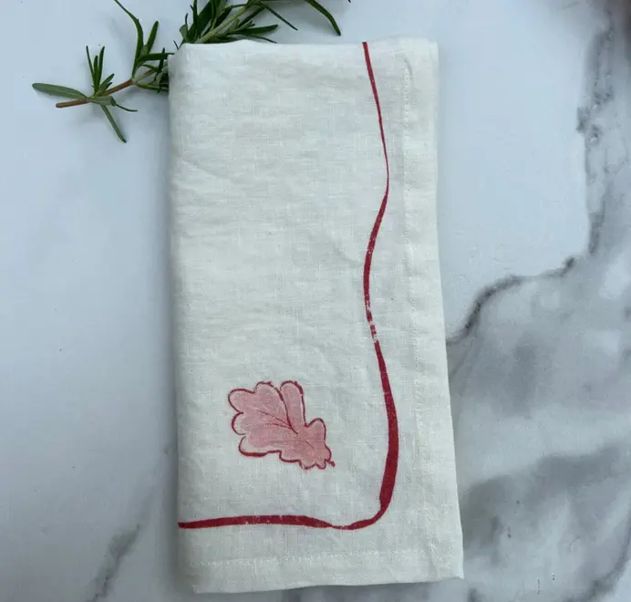 Oak Leaf Napkins (Set of 4). Light cloth napkin, folded on a marble table.