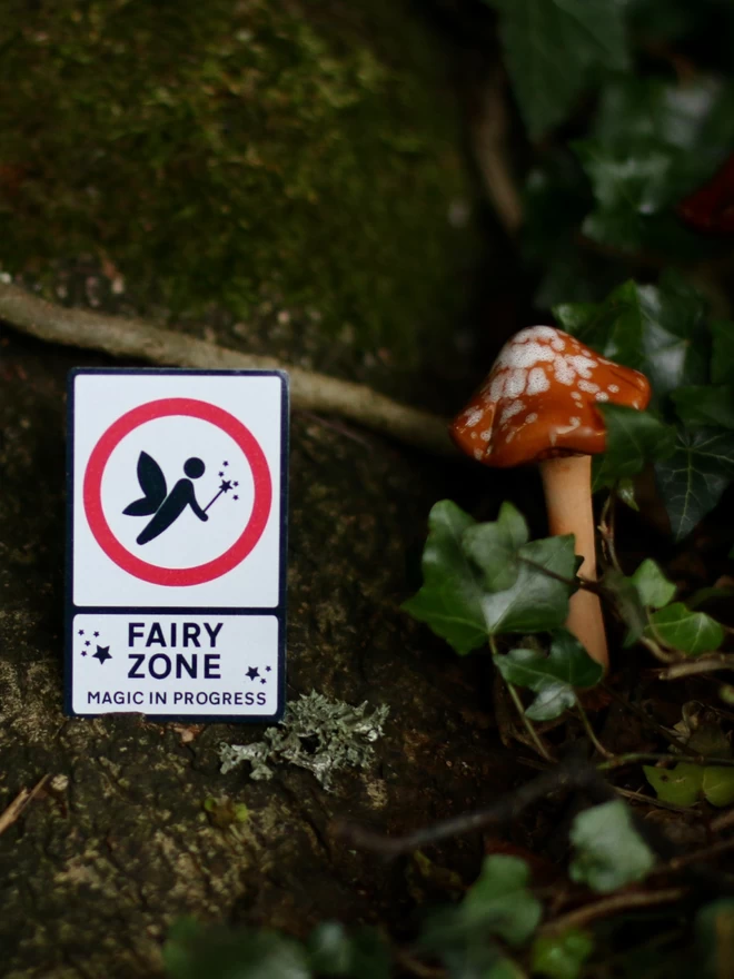 tiny fairy door sign by a toadstool