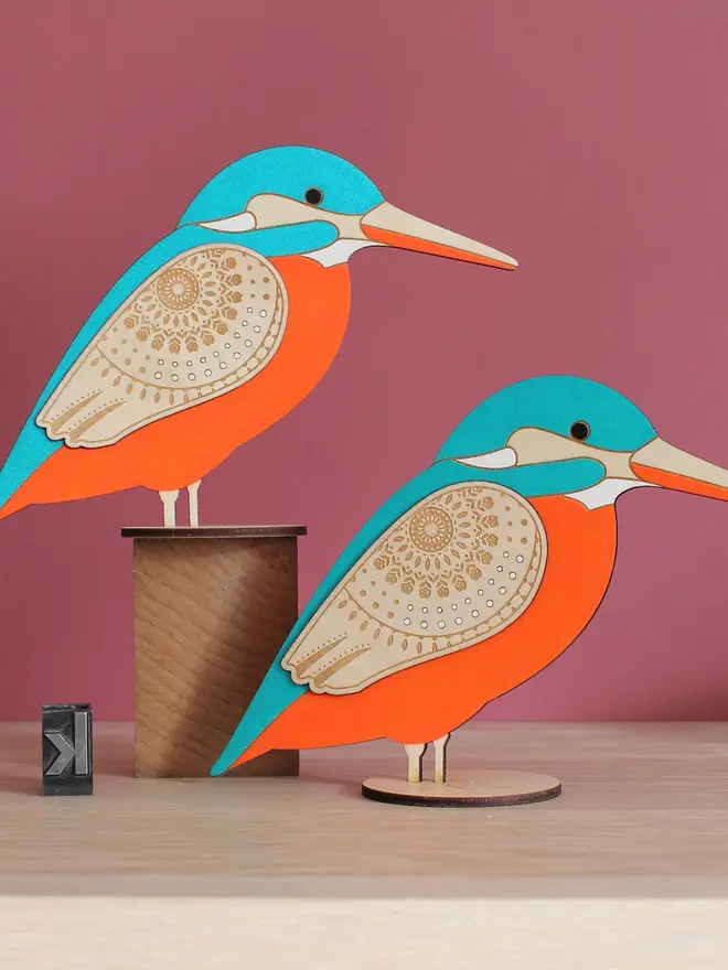 Standing Wooden Kingfisher, orange and blue wooden bird decoration standing on a platform. 