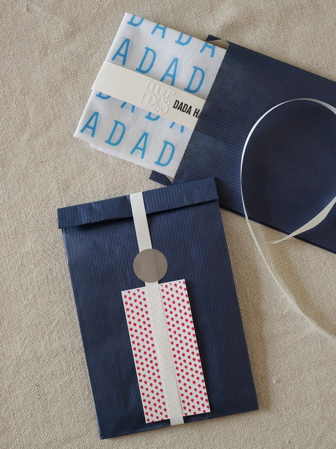 Optional gift wrap of navy paper, patterned gift card and ribbon