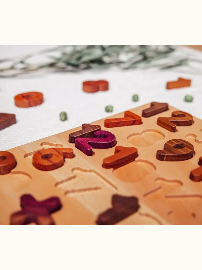 Extended Wooden Number Puzzle Heirloom Toy, on a table. 