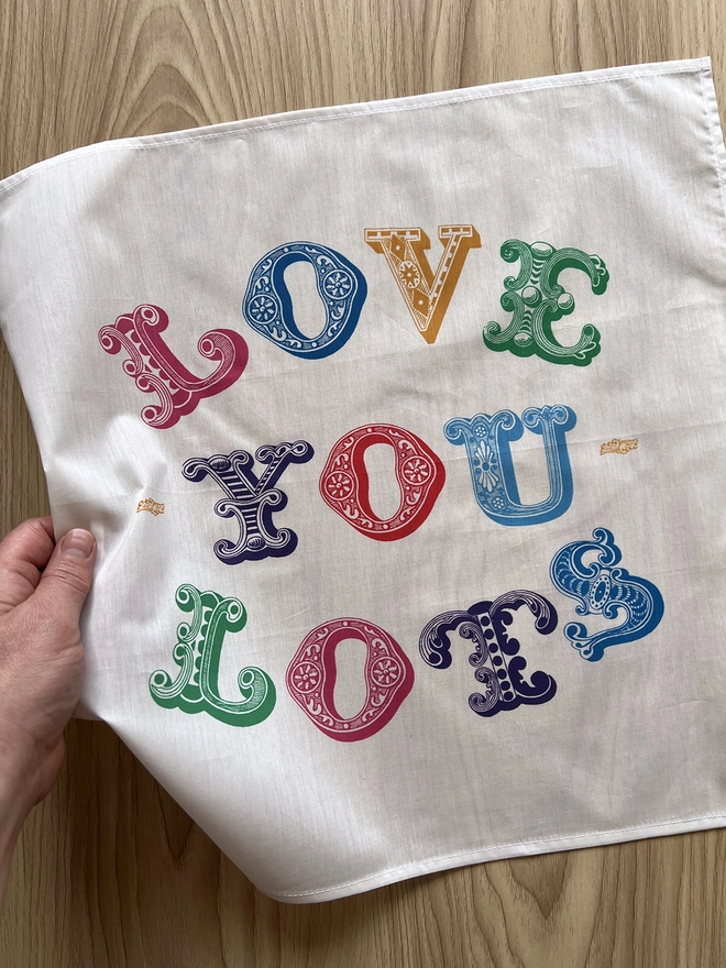A Mr.PS Love You Lots Multicolour handkerchief laid on a wooden table
