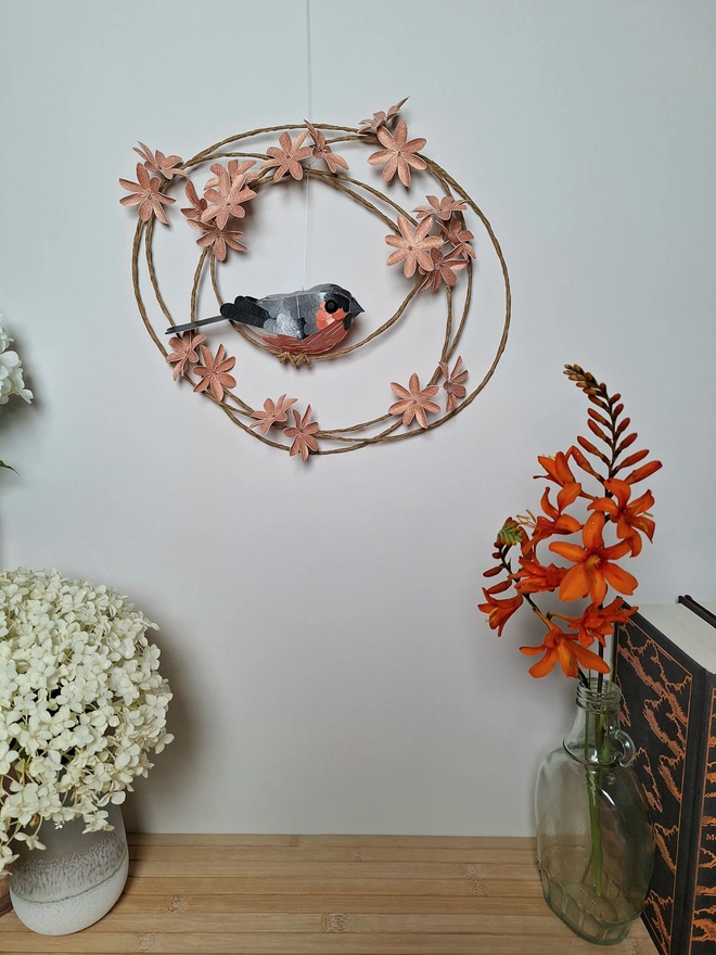 Handmade bullfinch bird sculpture on a floral wreath