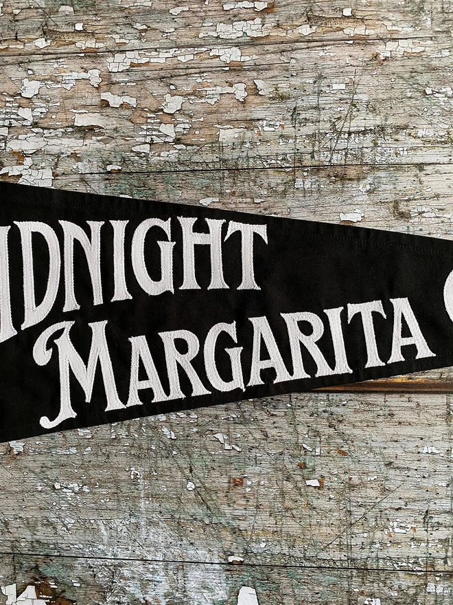 Black flag white writting Midnight Margarita Club Practical Magic