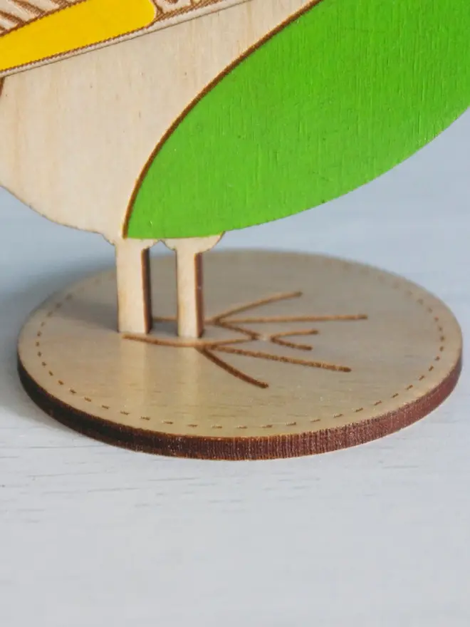 Standing Wooden Greenfinch, green wooden bird standing on a platform. 