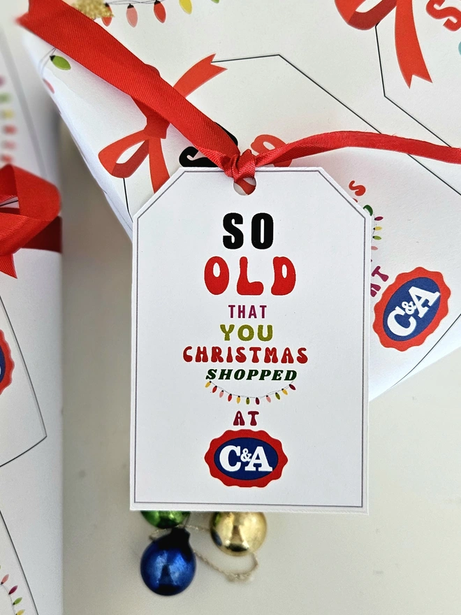 A gift tag on the present thats says so old that you Christmas shopped at C&A to match the paper.