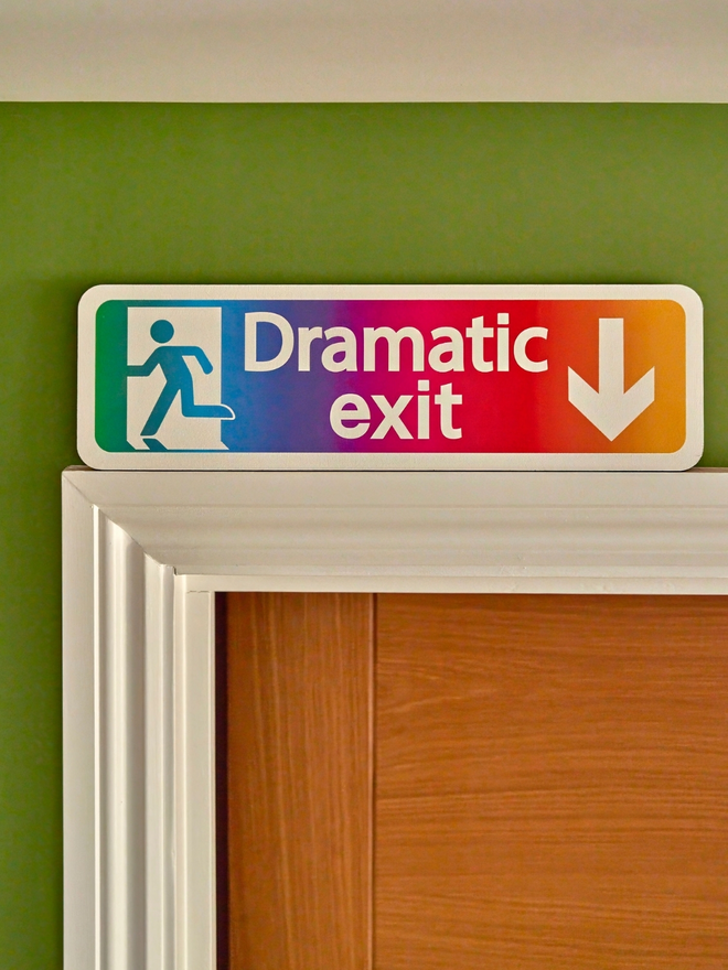 Rainbow dramatic exit sign. A sign which looks like an exit sign saying dramatic exit