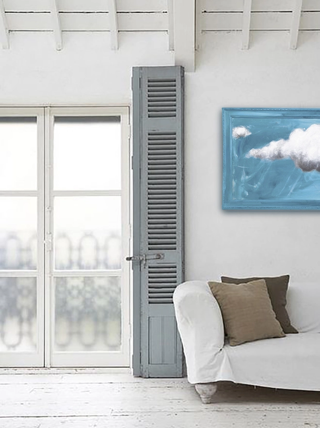 large cloud painting in turquoise painted directly onto a frame in a lounge
