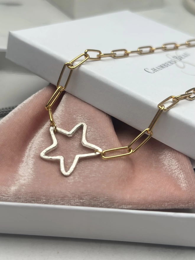 rough hewn sterling silver open star charm on gold paperclip chain with gift box and pouch