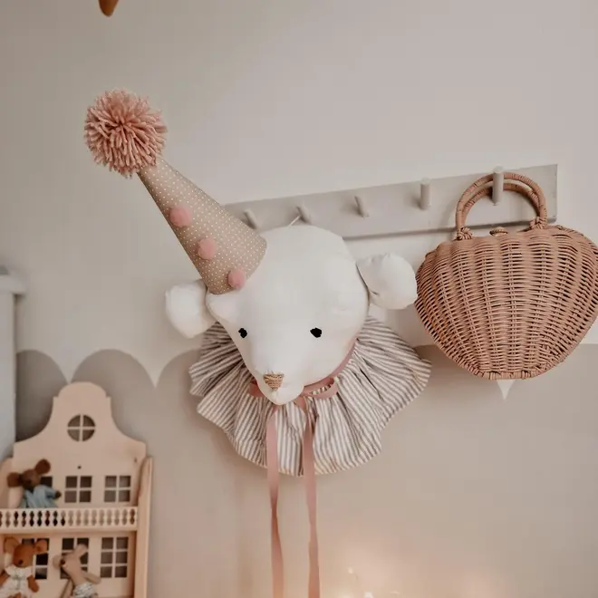 Bear Head Nursery Decoration, a bear decoration sitting against a wall in a child's decorated bedroom. 