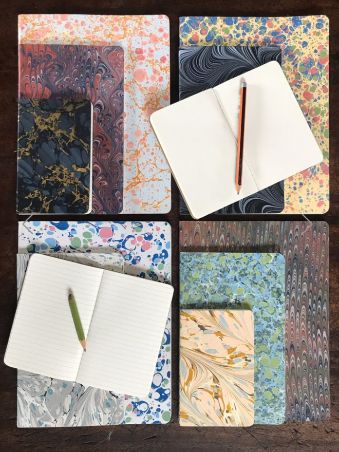 Notebooks. A selection of notebooks. Some are open.