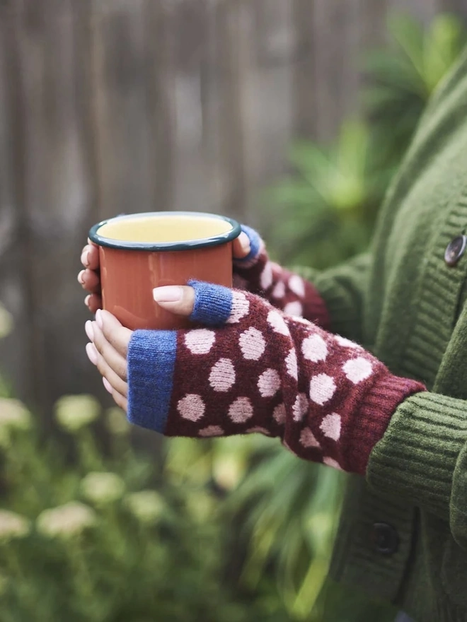 Enamel Tumbler, a colourful tumbler held by a person outside. 