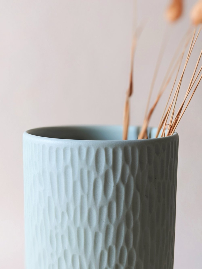 handmade textured pale blue vase with dried flowers