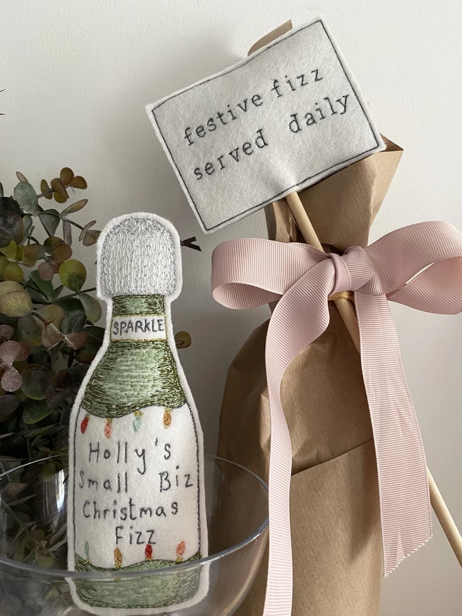 Festive fizz served daily sign on wrapped bottle with embroidered fizz bottle