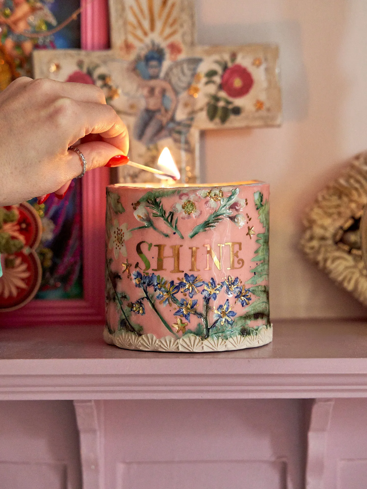 pink ceramic candle pot with floral decor and gold 'shine' text