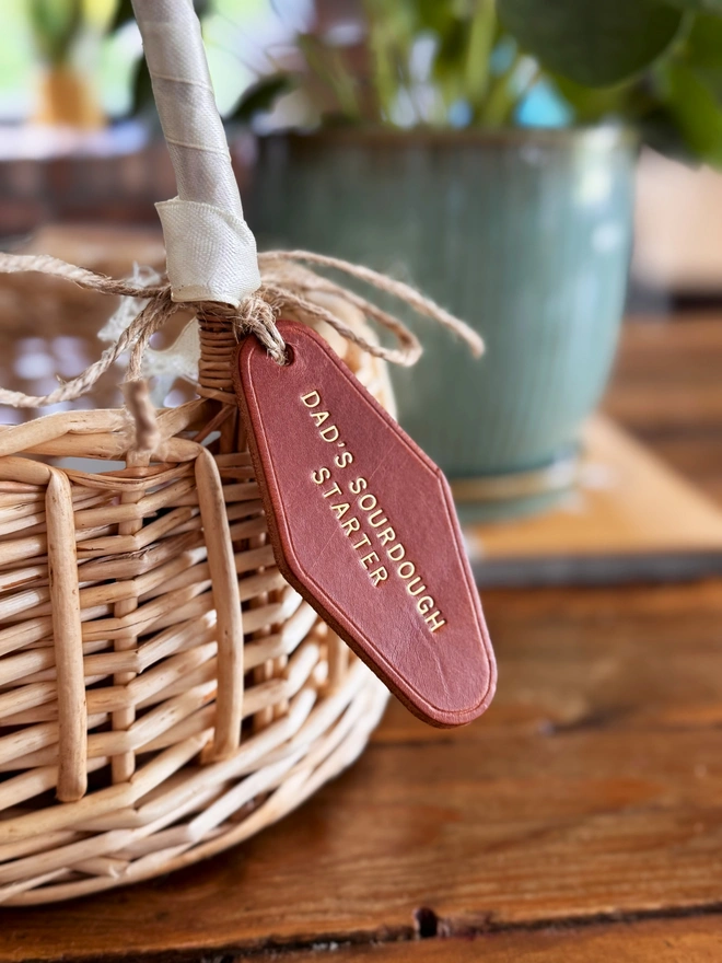 leather label with Dad's Sourdough Starter' written in gold on a tan tag