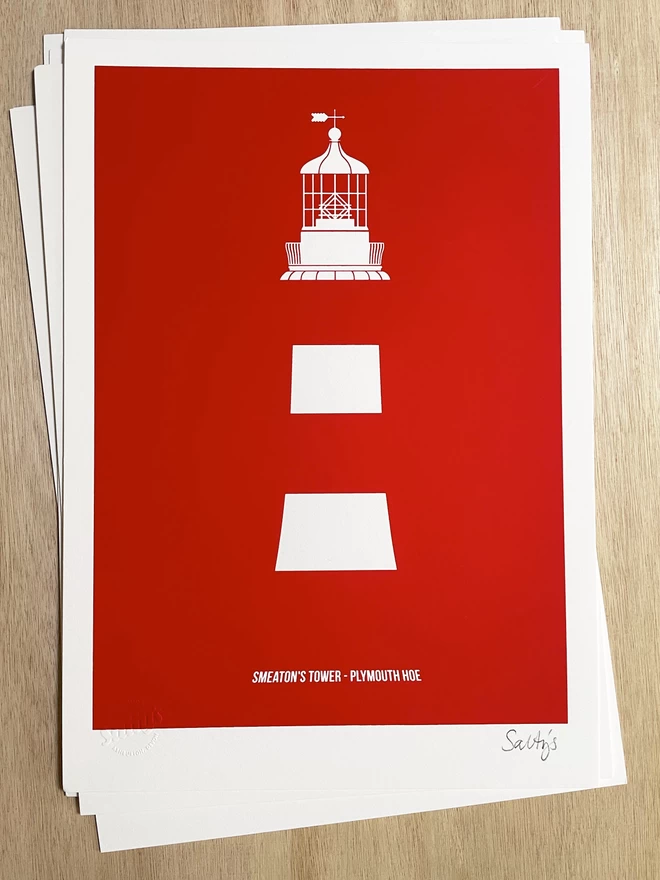 Smeaton’s Tower screenprinted in red ink on white paper, laid on a wooden table top, 