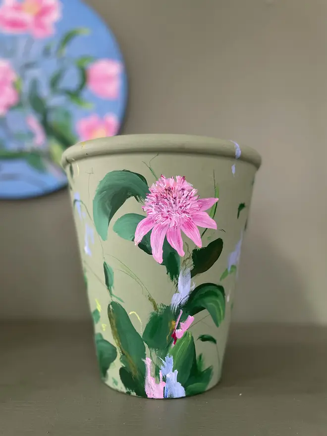 hand painted floral terracotta interior plant pot sage green background with pink pom echinacea flowers