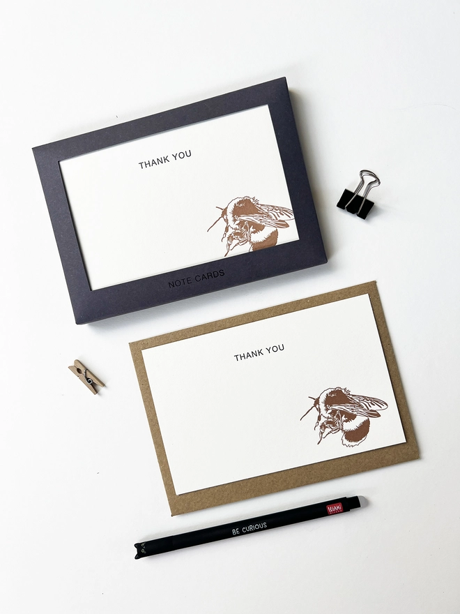 Boxed flat correspondence cards illustrated with a bumble bee