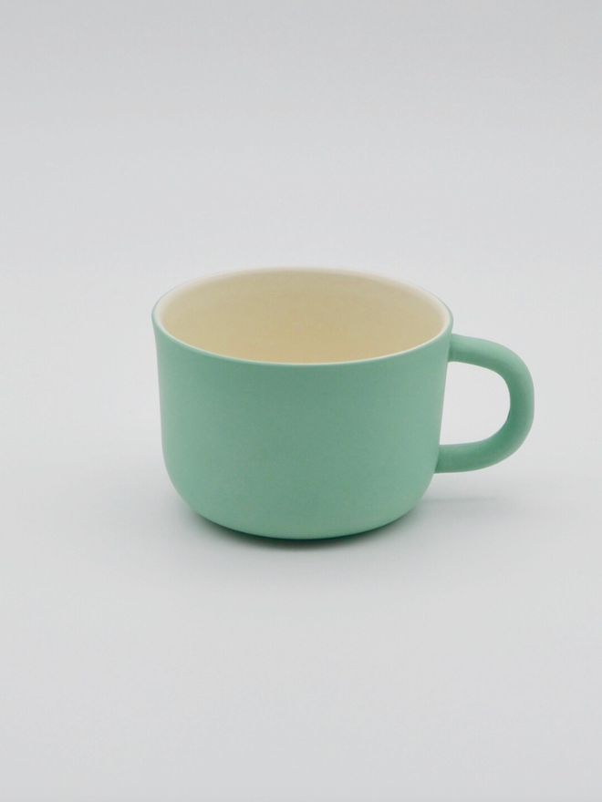 Handmade Porcelain Coffee Cup. A green coffee cup.