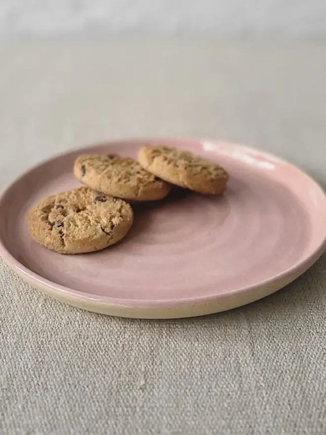 pink ceramic cake plate with textured swirl design